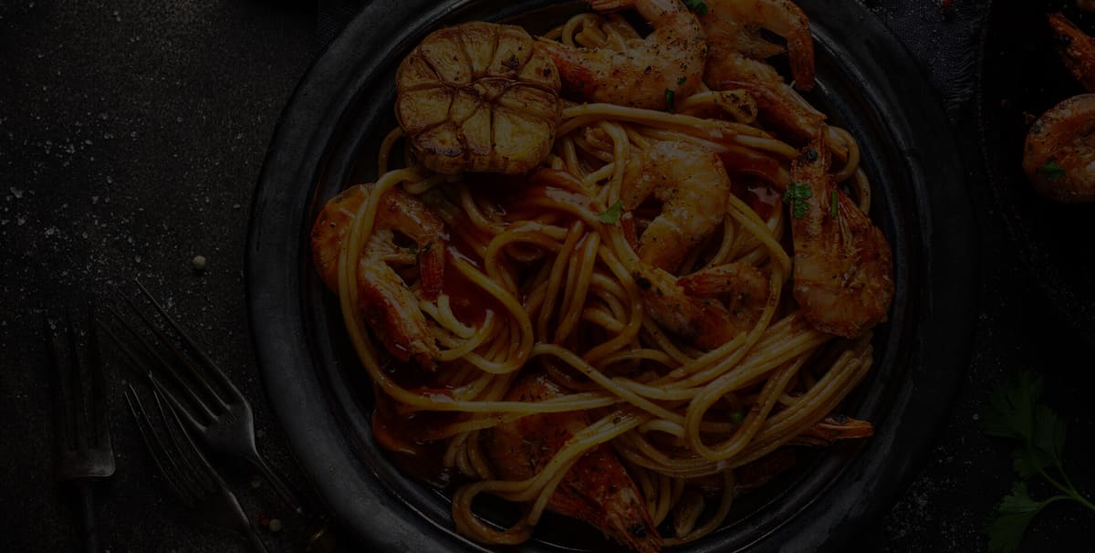 Seafood pasta in a dark bowl