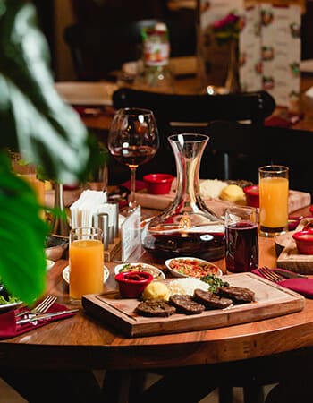 A table set with drinks and a grill platter