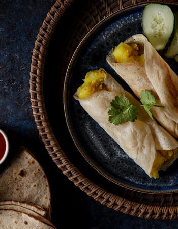 Stuffed flatbread wraps on a dark plate